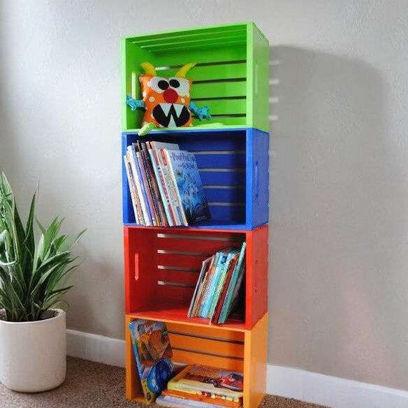 Homes & Luxury kids’ bookshelf made from painted wooden crates filled with books and toys