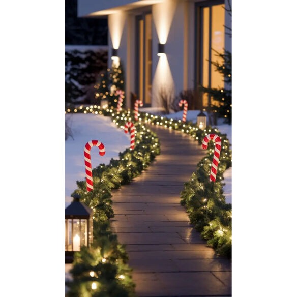 Christmas pathway lighting ideas with luminarias and candy cane stake lights lining walkway